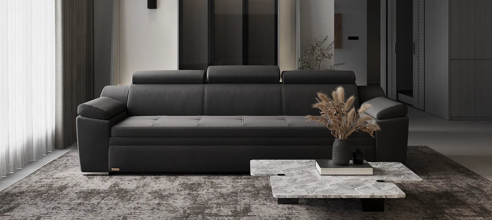Pilka Nelson sofa lova iš priekio su žemais porankiais ir plačia sėdyne.