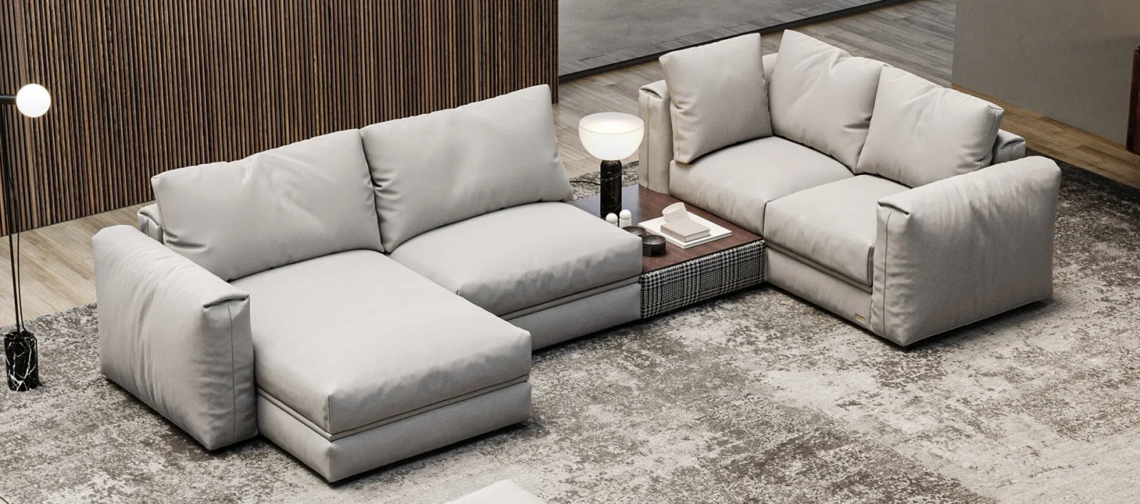 Pilka Dallas sofa lova šviesiame interjere su žemu korpusu ir plonomis tamsiomis kojelėmis.