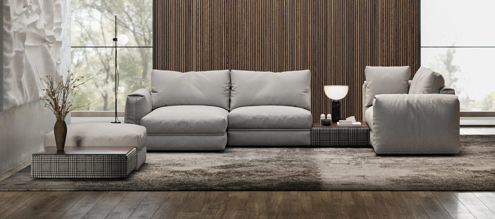 Pilka Dallas sofa lova su minkštomis pagalvėmis ir plačiais porankiais moderniame interjere.