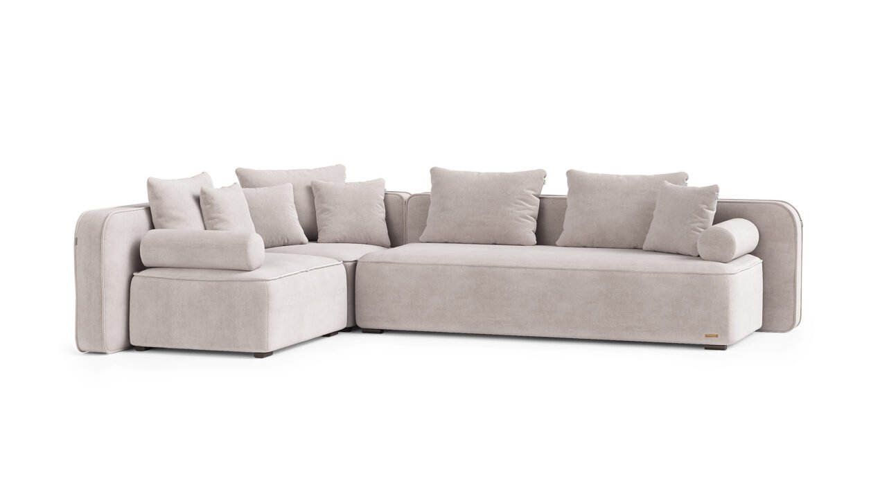 Norman kampinė sofa su plačiomis pagalvėmis ir žemu tekstiliniu profiliu.